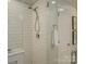 Modern walk-in shower featuring white subway tile, chrome fixtures, and glass door at 6116 Springhouse Ln, Charlotte, NC 28211