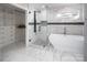 Sleek bathroom featuring a glass shower and modern freestanding tub alongside a walk-in closet with custom shelves at 6400 Morningsong Ln, Charlotte, NC 28269