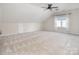 Large, carpeted bonus room with ceiling fan and natural light, perfect for recreation or relaxation at 6400 Morningsong Ln, Charlotte, NC 28269