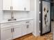 Chic butler's pantry with white cabinetry, marble countertops, and stylish hardware at 6400 Morningsong Ln, Charlotte, NC 28269