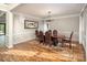 Traditional dining room featuring hardwood floors, wainscoting, and elegant chandelier at 6400 Morningsong Ln, Charlotte, NC 28269