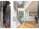 Grand foyer featuring a staircase, hardwood floors, decorative molding, chandelier and an open floor plan at 6400 Morningsong Ln, Charlotte, NC 28269