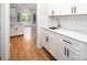 Charming kitchen features white cabinets, granite countertops, and stainless steel sink at 6400 Morningsong Ln, Charlotte, NC 28269