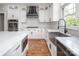 Modern kitchen with stainless steel appliances, an island, white cabinetry, marble countertops, and hardwood flooring at 6400 Morningsong Ln, Charlotte, NC 28269