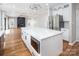 Bright, open-concept kitchen featuring an island, stainless steel appliances, and a view of the living room at 6400 Morningsong Ln, Charlotte, NC 28269