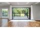 Bright living room with hardwood floors and folding doors to a deck and backyard at 6400 Morningsong Ln, Charlotte, NC 28269