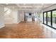 Open concept living area with hardwood floors, next to kitchen and deck access at 6400 Morningsong Ln, Charlotte, NC 28269