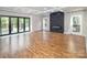 Bright living room features hardwood floors, modern fireplace, a coffered ceiling, and access to the deck at 6400 Morningsong Ln, Charlotte, NC 28269