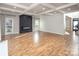Bright living room features hardwood floors, a coffered ceiling, and a modern fireplace at 6400 Morningsong Ln, Charlotte, NC 28269