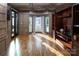 Living room showcasing hardwood floors, custom built-ins, and large bay window at 6400 Morningsong Ln, Charlotte, NC 28269