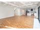 Open concept living area with hardwood floors, adjacent to the kitchen and staircase at 6400 Morningsong Ln, Charlotte, NC 28269