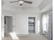 Spacious main bedroom with tray ceiling, ceiling fan, ensuite bathroom, and large windows at 6400 Morningsong Ln, Charlotte, NC 28269