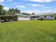 Expansive backyard with lush greenery, a covered shed and an attached screen porch at 714 Helms Efird Rd, Marshville, NC 28103