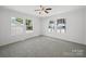 Bedroom with gray carpet, white walls, and two windows providing natural light at 714 Helms Efird Rd, Marshville, NC 28103