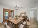 A dining room featuring a wooden table set for six, complemented by stylish decor and lighting at 714 Helms Efird Rd, Marshville, NC 28103
