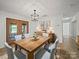 A dining room featuring a wooden table set for six, complemented by stylish decor and lighting at 714 Helms Efird Rd, Marshville, NC 28103
