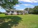 Charming single-story home with a welcoming front porch, manicured lawn, and an attached carport at 714 Helms Efird Rd, Marshville, NC 28103