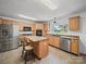 A well-equipped kitchen featuring stainless steel appliances and a center island with a breakfast bar at 714 Helms Efird Rd, Marshville, NC 28103