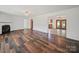 Open-concept living room showcasing hardwood floors, a fireplace, and seamless transitions to other rooms at 714 Helms Efird Rd, Marshville, NC 28103