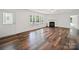 Bright living room with hardwood floors, a fireplace, and ample natural light through large windows at 714 Helms Efird Rd, Marshville, NC 28103