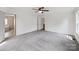 Spacious main bedroom featuring plush carpeting, a ceiling fan, and access to an ensuite bathroom at 714 Helms Efird Rd, Marshville, NC 28103