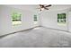 Comfortable main bedroom featuring neutral tones, carpet flooring, and natural light from multiple windows at 714 Helms Efird Rd, Marshville, NC 28103