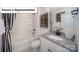 A full bathroom includes a granite vanity, framed mirror, and tub shower combination at 7184 Sylvan Retreat Dr, Denver, NC 28037