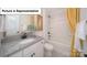 Bright bathroom with a granite vanity, white cabinets, and a tub and shower combination at 7184 Sylvan Retreat Dr, Denver, NC 28037