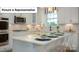Close up of kitchen island featuring quartz countertops, sleek appliances, and open layout at 7184 Sylvan Retreat Dr, Denver, NC 28037