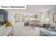 Open living room features contemporary decor, lots of light, and neutral paint at 7184 Sylvan Retreat Dr, Denver, NC 28037