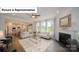 Cozy living room featuring a fireplace, hardwood floors, and lots of natural light at 7184 Sylvan Retreat Dr, Denver, NC 28037