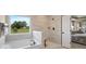 Bathroom with soaking tub, tile shower, and picturesque outdoor view at 7191 Sylvan Retreat Dr, Denver, NC 28037