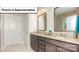 Well-lit bathroom featuring double vanity with granite counters and modern fixtures at 7196 Sylvan Retreat Dr, Denver, NC 28037
