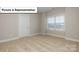 Neutral bedroom featuring a window, carpet flooring, and base trim at 7196 Sylvan Retreat Dr, Denver, NC 28037