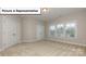 Bedroom with large windows offering plenty of natural light and neutral carpeting at 7196 Sylvan Retreat Dr, Denver, NC 28037