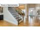 Inviting foyer showcasing hardwood floors, a staircase with wrought iron railings, and a view into the dining room at 7196 Sylvan Retreat Dr, Denver, NC 28037