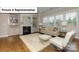 Cozy living room with fireplace, built-in shelving and hardwood floors at 7196 Sylvan Retreat Dr, Denver, NC 28037