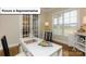 Sunlit office featuring a white desk, hardwood floors, and large windows offering a pleasant view at 7196 Sylvan Retreat Dr, Denver, NC 28037