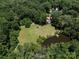 Expansive property featuring a well maintained yard, mature trees, and a small pond at 7356 Terrace Dr, Charlotte, NC 28211