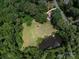 Expansive property with a beautiful home, pond, and lush greenery, showcasing a private and serene setting at 7356 Terrace Dr, Charlotte, NC 28211
