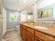 Bathroom featuring double vanity, granite countertops, and natural light from a window at 7356 Terrace Dr, Charlotte, NC 28211