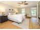 Comfortable bedroom featuring hardwood floors, a ceiling fan and natural light at 7356 Terrace Dr, Charlotte, NC 28211
