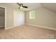 Bedroom featuring a ceiling fan and natural light from a window with a double-door closet at 7356 Terrace Dr, Charlotte, NC 28211