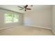 Neutral bedroom features a ceiling fan and a sunny window at 7356 Terrace Dr, Charlotte, NC 28211