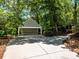 Detached carport with spacious driveway provides ample parking and enhances the property's curb appeal at 7356 Terrace Dr, Charlotte, NC 28211