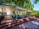 Expansive covered deck features multiple seating areas and lovely backyard views, ideal for outdoor living at 7356 Terrace Dr, Charlotte, NC 28211