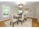 An elegant dining room with neutral decor, a round table, and large windows at 7356 Terrace Dr, Charlotte, NC 28211