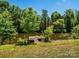 Lakeside property featuring a private dock surrounded by mature trees, perfect for relaxing and enjoying nature at 7356 Terrace Dr, Charlotte, NC 28211