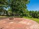 Charming backyard fire pit area with brick pavers, ideal for cozy evenings and gatherings at 7356 Terrace Dr, Charlotte, NC 28211