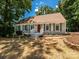 Charming single-story home with a neutral exterior, shutters, and a welcoming front porch at 7356 Terrace Dr, Charlotte, NC 28211